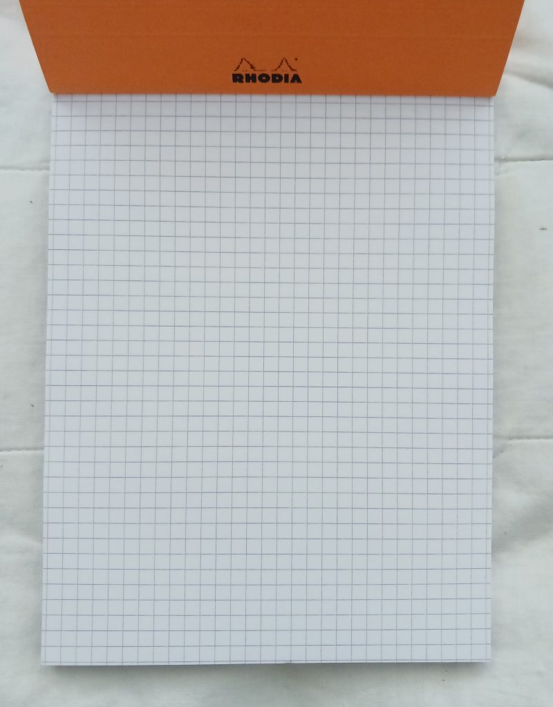 A5-sized grided notebook. 